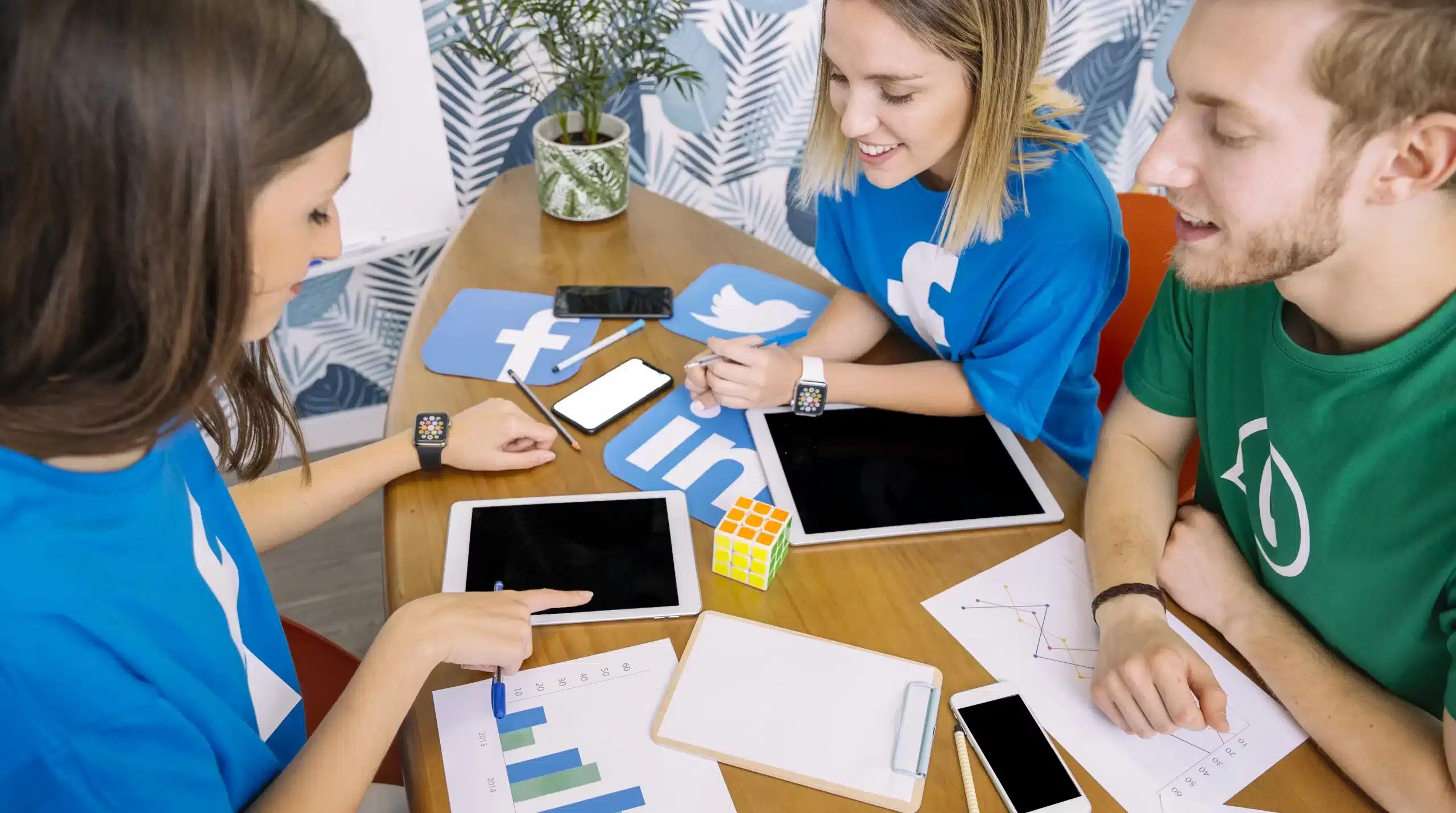 group people looking digital tablet with social media icons workplace scaled e1708716068302